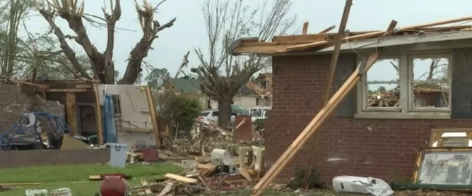 Damaged house after a tornado, showing extensive destruction.