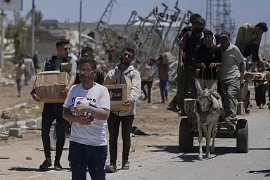 Palestinians receiving aid boxes from a US-backed humanitarian organization in Gaza