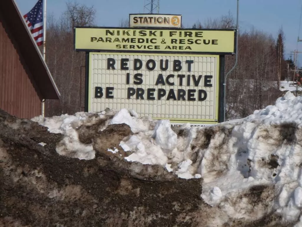 Trees Could Be Nature's Spy Network for Predicting Volcano Eruptions a sign near anchorage warning that the rebout volcano is active credit public domain