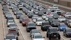 Traffic congestion on Interstate 805 near San Diego, California, showing a line of cars approaching the border crossing into Tijuana, Mexico.
