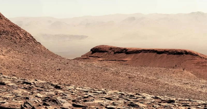 Detailed view of rocky Martian terrain and layered hills within Gale Crater captured by the Curiosity rover.