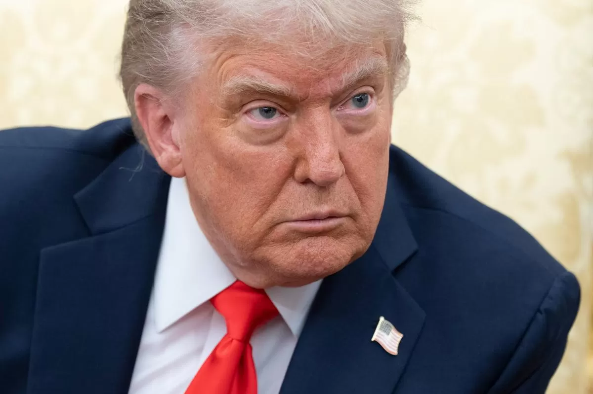 US President Donald Trump sits at the Resolute Desk in the Oval Office