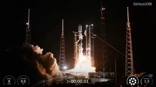 SpaceX Falcon 9 rocket lifting off from Florida launchpad against dark sky