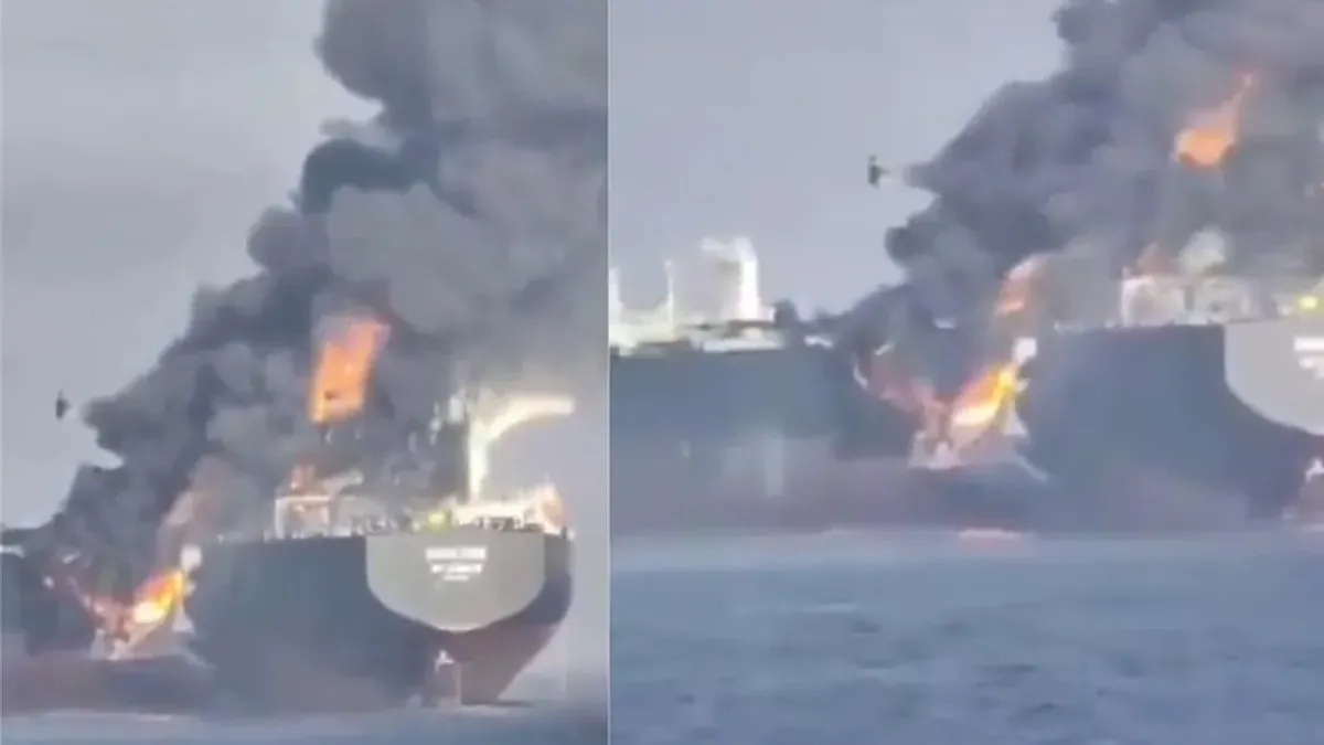 Screenshot from a video showing the tanker Adalynn ablaze after a collision in the Gulf of Oman, with smoke visible.