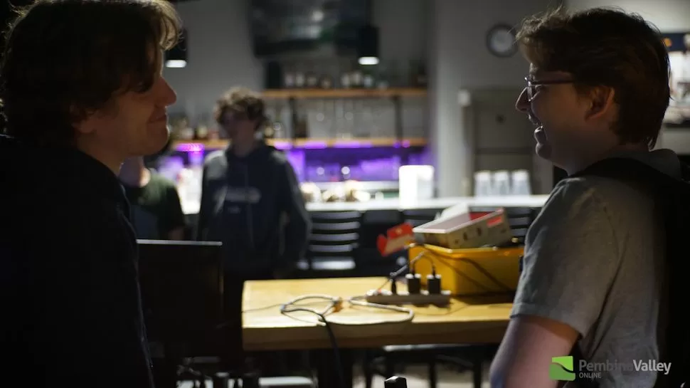 Two people laughing and smiling at a gaming tournament, representing the friendly community atmosphere