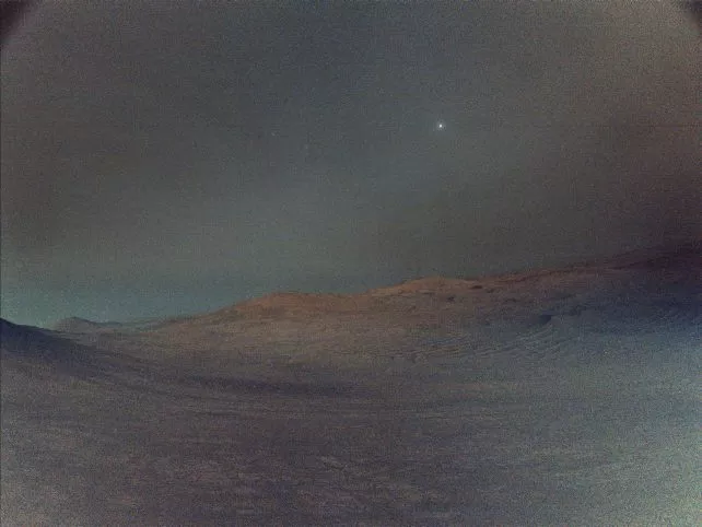Mars Perseverance rover's view of the moon Deimos shining faintly in the pre-dawn Martian sky above Jezero Crater