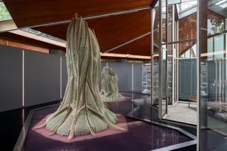 Tree trunk shaped structure made of living building material at architecture exhibition in Venice.