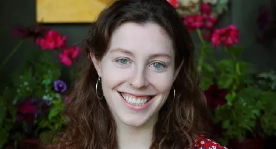 Alice Curtin, one of the first Canadian SKA Scientists, who studies fast radio bursts, smiling in a red floral shirt