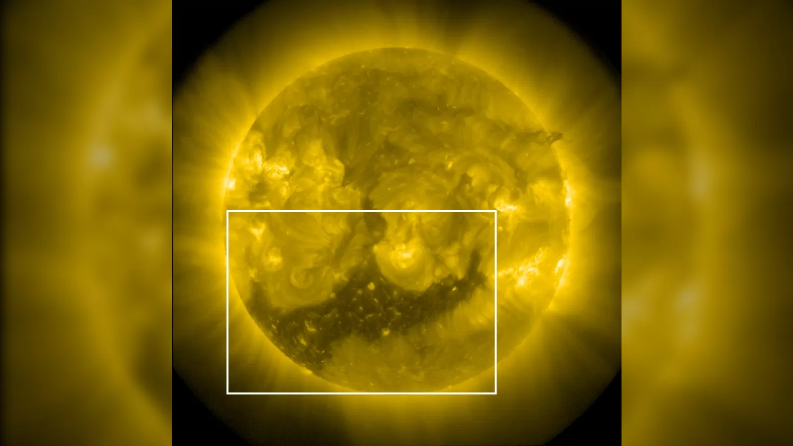 The sun showing a large dark region known as a coronal hole in its southern hemisphere.