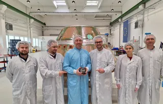 Scientists in a clean room at The Exploration Company facility handling the Celestis human remains payload capsule before the Transporter-14 launch.