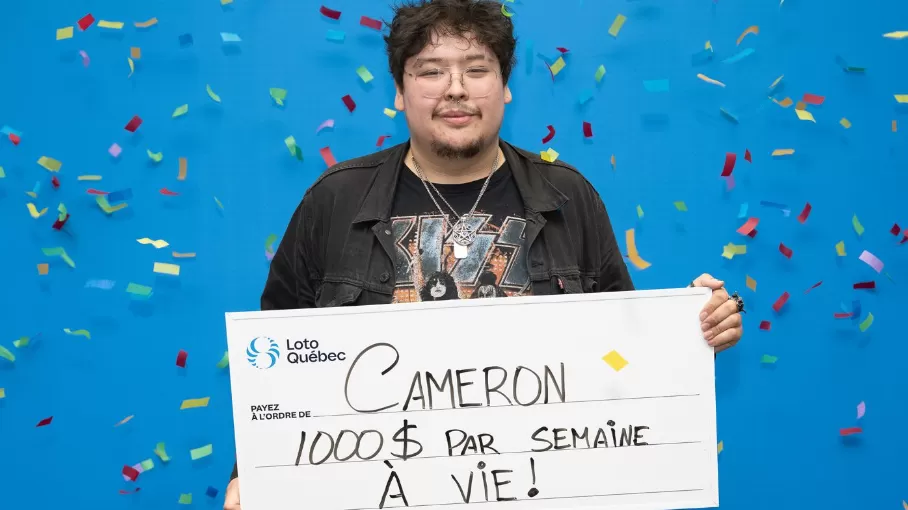 Young man holding large lottery cheque