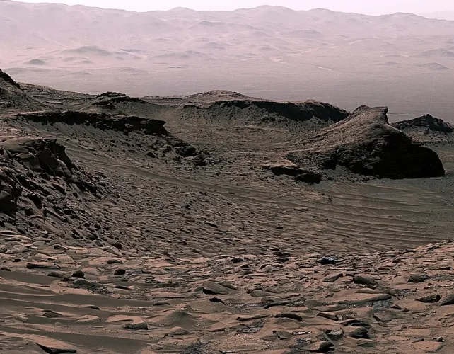 NASA's Curiosity rover investigates ancient rock containing carbonate minerals on Mars, offering clues to the planet's dry climate history.